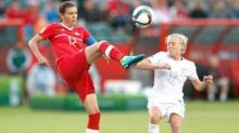 EDMONTON, AB - JUNE 11: Christine Sinclair (L) of Canada kicks the ball in front of Betsy Hassett of New Zealand during the FIFA Women's World Cup Canada Group A match between Canada and New Zealand at Commonwealth Stadium on June 11, 2015 in Edmonton, Alberta, Canada. (Photo by Todd Korol/Getty Images)