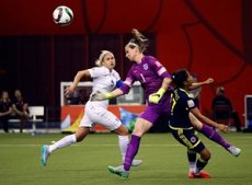 Karen Bardsley clatters into Carolina Arias as she blocks the ball with her face.