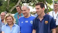 Prime Minister Benjamin Netanyahu and his wife, Sara, walk alongside FC Barcelona superstar Lionel Messi, Sunday, August 4, 2013 (photo credit: Avi Ohayon/GPO/Flash90)