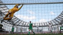 Some action: England goalkeeper Joe Hart swings on the crossbar.