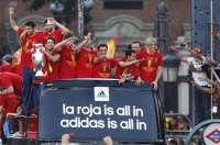 Spain's national soccer team players celebrate their Euro 2012 victory on an open top bus during a parade in downtown Madrid July 2, 2012. Spaniards seized on their Euro 2012 triumph as a source of restored national pride after months of economic anxieties, as celebrations were set to reach fever pitch on Monday with a victory parade in the capital. REUTERS-Andrea Comas